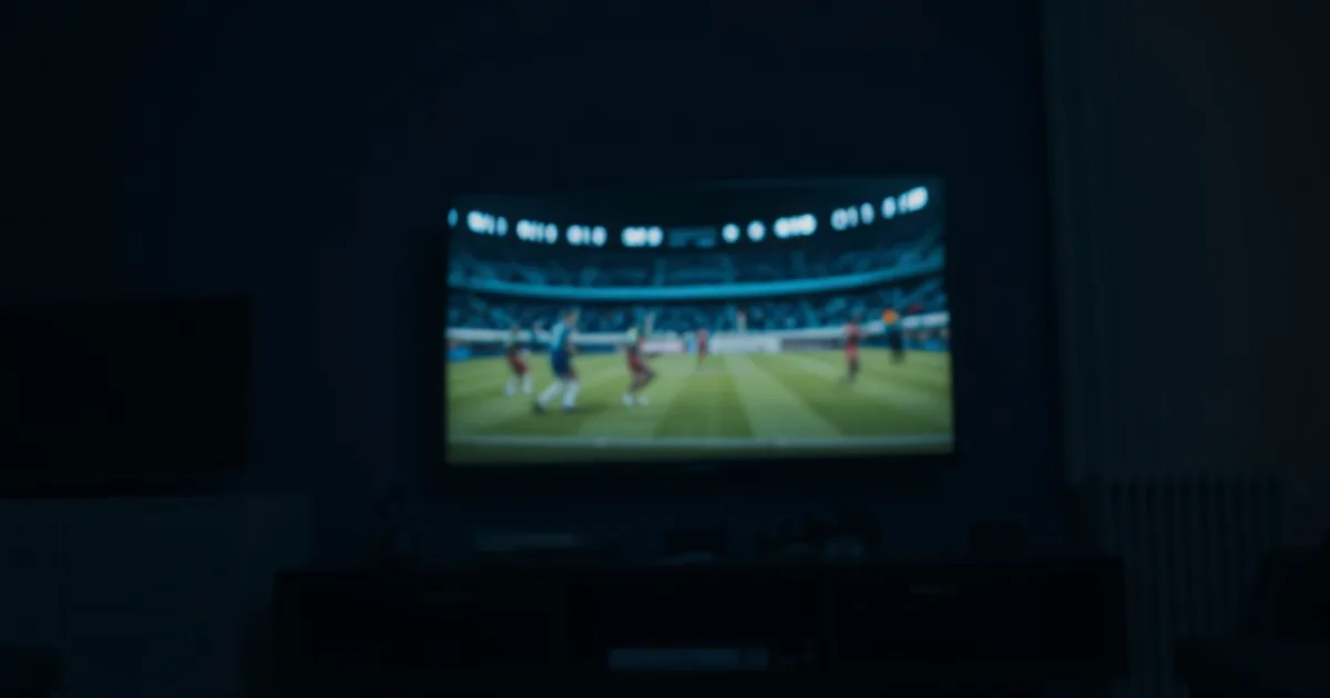 Mørkt stuemiljø om aftenen med et tv og flere enheder, der streamer fodbold samtidig, som symbol på at teste en IPTV-udbyders stabilitet